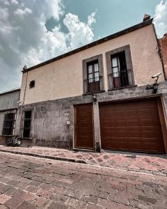 a building with two brown garage doors on it at Talavera II in Querétaro