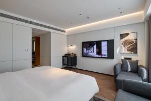 TV a/nebo společenská místnost v ubytování Panjin Xianghai Avenue Intercity Hotel