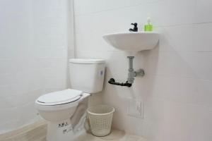 a white bathroom with a toilet and a sink at Apartaestudios la terraza 1 in Sincelejo