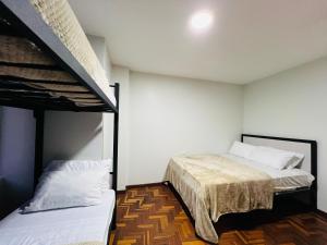 two beds in a room with two bunk beds at Basilica Apartment 3 Bed 2 Bath in Baños