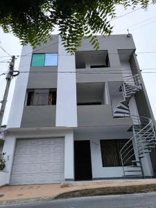 a white apartment building with a fire escape at Apartaestudios la terraza 3 in Sincelejo