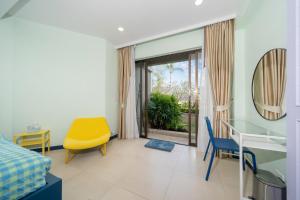 a room with a bed and a table and chairs at Allamanda Laguna Phuket in Laguna Phuket +14 photos