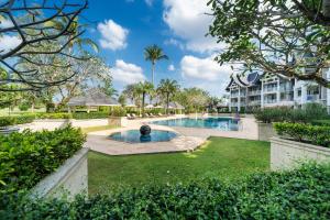 an exterior view of a villa with a swimming pool at Allamanda Laguna Phuket in Laguna Phuket