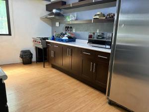 a kitchen with a stainless steel refrigerator and wooden floors at Departamento Independiente in Morelia +10 photos