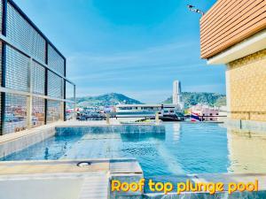 a swimming pool on the roof of a building at The Album Hotel in Patong Beach +60 photos