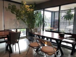 a dining room with a wooden table and chairs at BaanTip​ HomeStay in Amphoe Phra Khanong