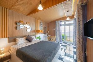 a bedroom with a bed and a television in a room at La Cle' Đà Lạt in Da Lat