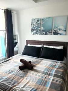 a teddy bear laying on top of a bed at Azure Staycation by Casa Lepap in Manila