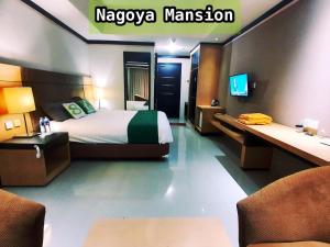 a hotel room with a bed and a tv at Nagoya Mansion Apartment by Homestay81 in Nagoya
