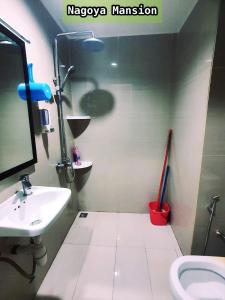 a bathroom with a sink and a toilet and a mirror at Nagoya Mansion Apartment by Homestay81 in Nagoya