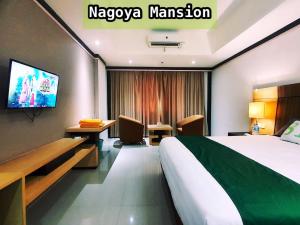 a hotel room with a bed and a tv at Nagoya Mansion Apartment by Homestay81 in Nagoya +3 photos