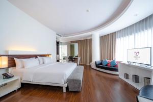 Rúm í herbergi á Sensa Hotel Bandung