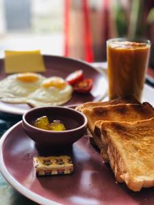 a plate with toast and eggs and a cup of coffee at Villa Dream D in Hikkaduwa +26 photos