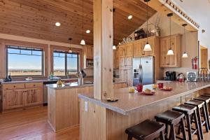 a large kitchen with wooden cabinets and a large island at Hint of Heaven in Island Park