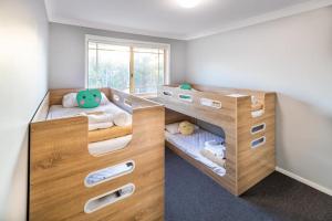 a bedroom with two bunk beds and a window at Ingenia Holidays One Mile Beach in One Mile