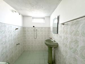 a bathroom with a green toilet and a sink at Shanti House in Weligama +59 photos