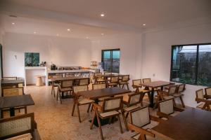 a restaurant with wooden tables and chairs in a room at Ruby Hotel in Vientiane