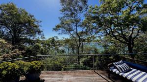 a bench sitting on top of a wooden deck at 'Pretty Beach Escape' by HolidayCo in Pretty Beach