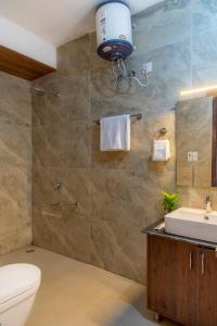 a bathroom with a toilet and a sink at Host jatin Mountain Bibes Kasauli 7o1827o7o3 in Kasauli +13 photos