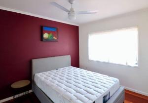 a bedroom with a white bed and a window at 5 36 Maurice Avenue in Mallacoota