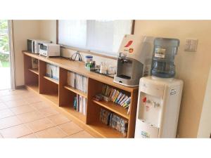 a kitchen with a counter with a coffee maker and a refrigerator at Pine Shima Resort Coral Fish - Vacation STAY 37429v in Ibaruma