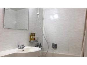 a bathroom with a sink and a shower with a mirror at Pine Shima Resort Coral Fish - Vacation STAY 37429v in Ibaruma +32 photos