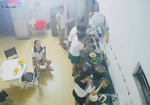 a group of people standing around a table in a kitchen at View Nhat Le Beach Hotel in Dong Hoi