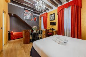 a bedroom with a bed and red curtains at Ca Dell'Arte in Venice