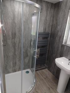 a shower with a glass door in a bathroom at 198 Headwards Retreat in Hemsby