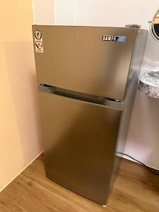 a stainless steel refrigerator sitting in a kitchen at 翹班旅行民宿 in Magong