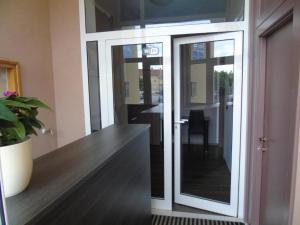 a sliding glass door in a room with a table at Mikulić Apartments in Zadar