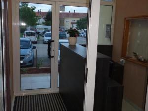 a sliding glass door with a view of a parking lot at Mikulić Apartments in Zadar