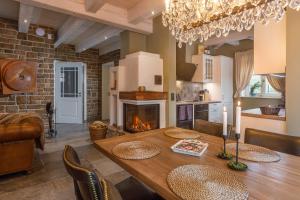 a kitchen and dining room with a table and a fireplace at Landhäuser Ottilienruh in Ilsenburg