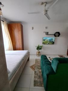 a living room with a bed and a couch at Phoina Homes in Mombasa
