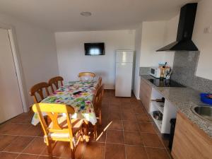 a kitchen with a table and chairs in a kitchen at Pensíon Lucia in Casinos