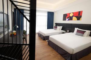 Postel nebo postele na pokoji v ubytování Bespoke Hotel Puchong