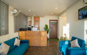 a living room with blue couches and a counter at Perfectstayz Value Valley Vista 5 min walk to Mall road in Mussoorie +62 photos