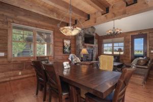 a dining room with a wooden table and chairs at 19th Hole cabin in Granby