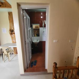 a view of a bathroom from the hallway of a house at Boone Homestay in Sagada