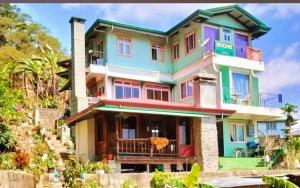 a home with a colorful house at Boone Homestay in Sagada