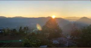 a view of the sun setting over the mountains at Boone Homestay in Sagada
