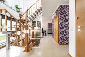 a staircase in a house with a hallway with a living room at Serra e Mar Refuge in Sesimbra - Family Friendly home near the Arrábida Beachs in Sesimbra