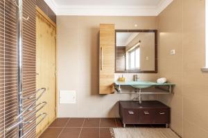 a bathroom with a sink and a mirror at Serra e Mar Refuge in Sesimbra - Family Friendly home near the Arrábida Beachs in Sesimbra +48 photos