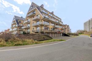 a large apartment building on the side of a street at Tivoli, 0103 in Oostduinkerke