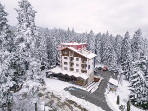 an aerial view of a hotel with snow covered trees at The Lodge Hotel in Borovets