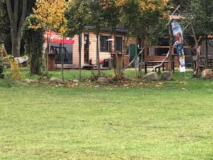 a park with a house in the background at Ferienhaus "Cajo" am Malchiner See in Dahmen
