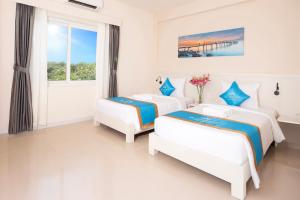 Ένα ή περισσότερα κρεβάτια σε δωμάτιο στο KLC Holidays Phu Quoc Hotel