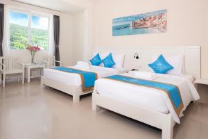 Ένα ή περισσότερα κρεβάτια σε δωμάτιο στο KLC Holidays Phu Quoc Hotel
