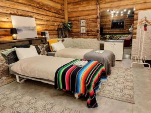 two beds in a room with wooden walls at Self check-in Rustic Studio next to Nature Reserve in Kärde