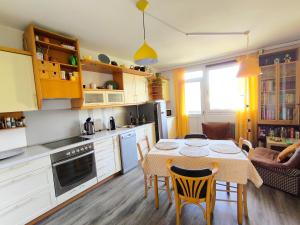 a kitchen with a table and chairs and a kitchen with a table and a table at Comfy and central with bikes in Bohinj